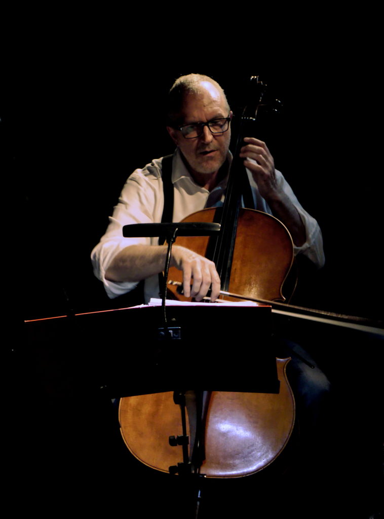 Ivan playing the cello in the dark